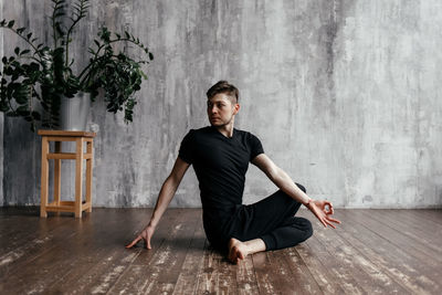 A man engaged in yoga and meditation, performing asanas