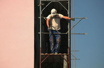 Rear view of man standing against sky