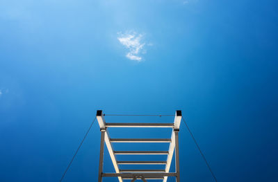 Low angle view of cables against blue sky