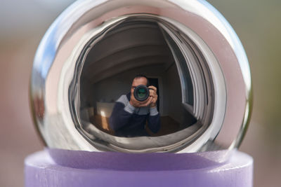 Close-up portrait of man photographing camera