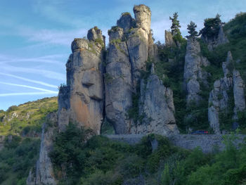 Low angle view of rock formation against sky