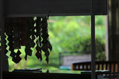 Close-up of hanging from window