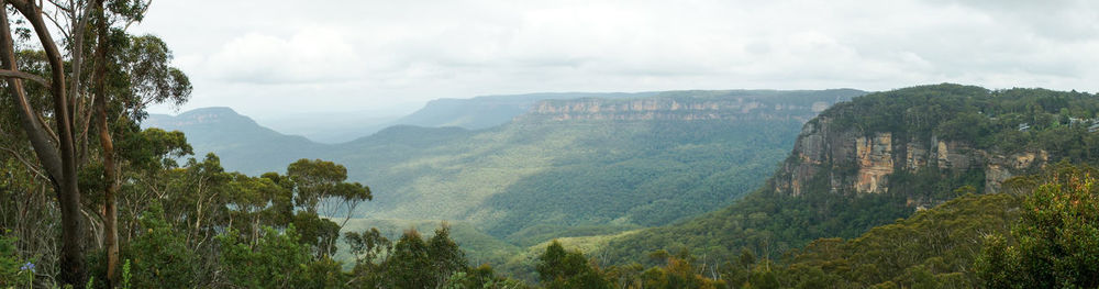 Scenic view of mountains against cloudy sky