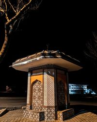 Low angle view of illuminated building against sky at night