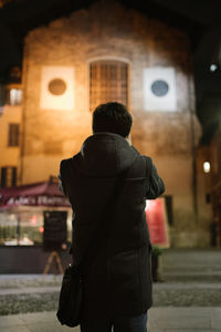 Rear view of woman standing in city