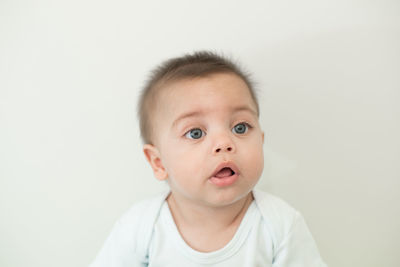 Portrait of cute boy against white background