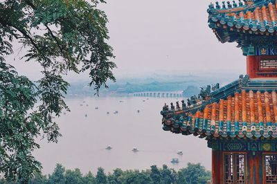 Panoramic view of buildings and trees against sky