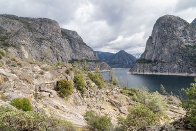 Scenic view of mountains against cloudy sky