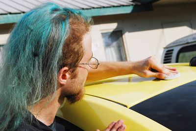 Close-up of man cleaning car