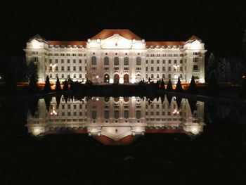 Reflection of illuminated buildings in water at night