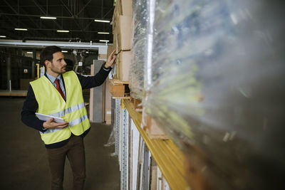 Man in warehouse supervising stock