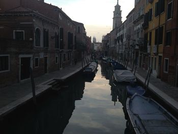 Boats in canal along buildings