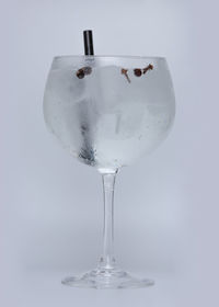 Close-up of wineglass on table against white background