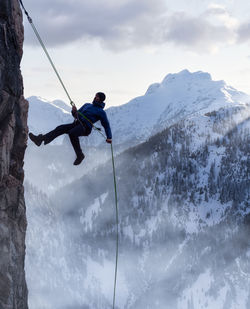 Full length of person on snowcapped mountain against sky