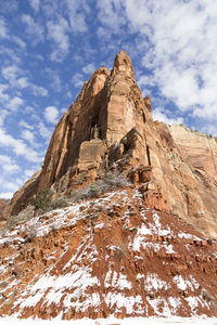 Low angle view of rock formation against sky