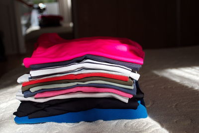 Colorful clothes on the bed in the sunlight