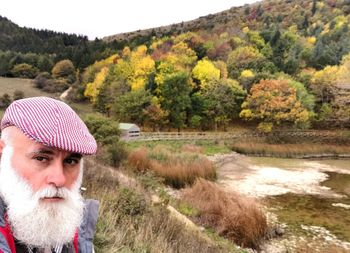 Portrait of bearded man against trees during autumn