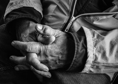 Close-up of hands and woman at home