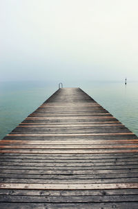 Pier over sea against clear sky