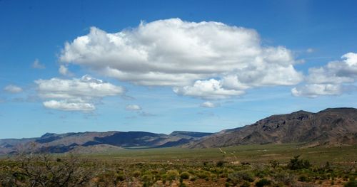 Scenic view of mountains against cloudy sky