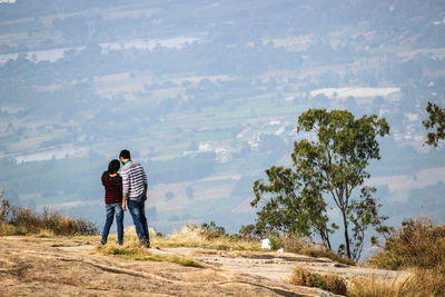 Rear view of couple standing on mountain