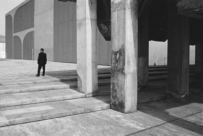 Rear view of businessman standing on footpath