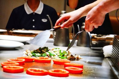 Cropped hands of chef preparing food in restaurant