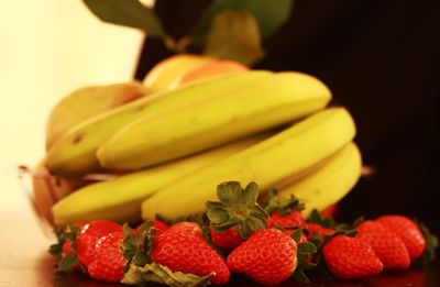 Close-up of bananas and strawberries on table