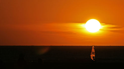 Scenic view of sea against orange sky