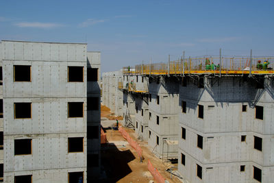 High angle view of buildings in town against sky