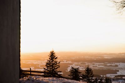 Scenic view of snow covered landscape against sky during sunset