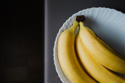 Ripe yellow bananas in a plate on the table. high quality photo