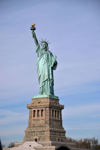 Low angle view of statue of liberty against sky