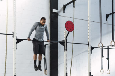 Young athlete doing crossfit training in gym