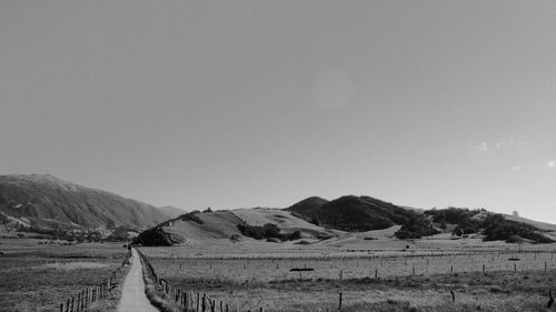 Scenic view of landscape and mountains against clear sky