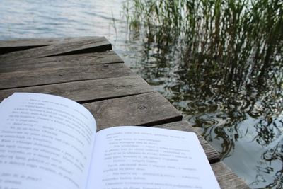 Close-up of open book by water