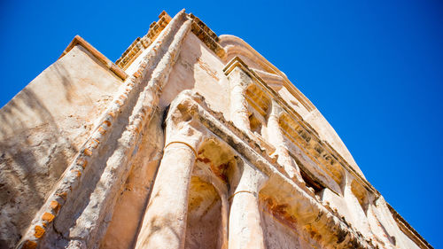 Low angle view of old ruin against clear blue sky during sunny day