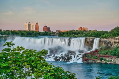 Scenic view of niagara falls canada onto niagara falls us side with waterfall long exposure sunset