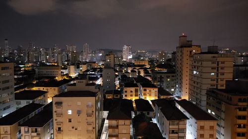 High angle view of illuminated buildings in city at night