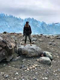 Full length of woman standing at beach during winter