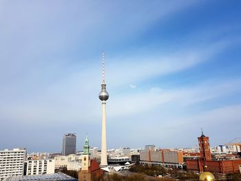 Tower amidst buildings in city against sky