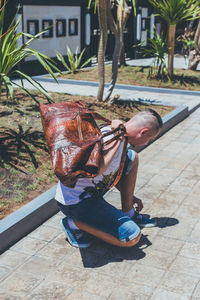 Man with python skin travel bag