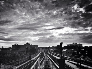 Railroad track against cloudy sky