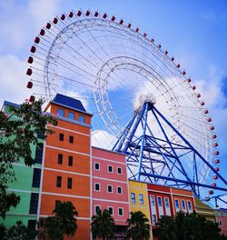 Low angle view of ferris wheel against sky