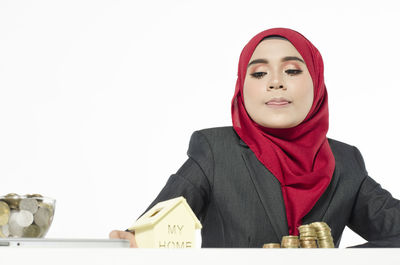 Portrait of young woman against white background