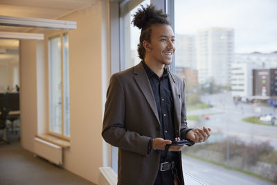 Smiling man standing in office