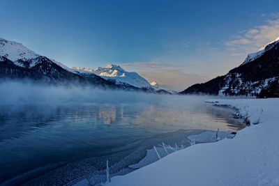 Scenic view of snowcapped mountains against sky during winter