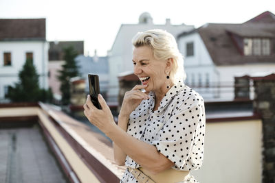 Woman using mobile phone outdoors