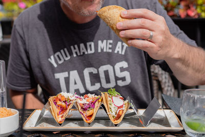 Midsection of man holding food