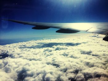 Aerial view of aircraft wing over clouds